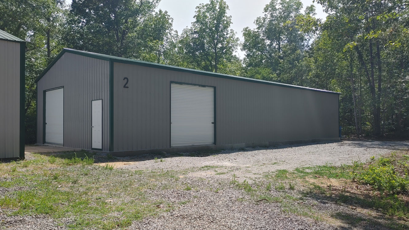 30' wide, 70' long, 12' tall Pewter and Green metal garage with Green vertical metal roof and Pewter vertical metal siding, anchored to Monolithic Concrete Foundation